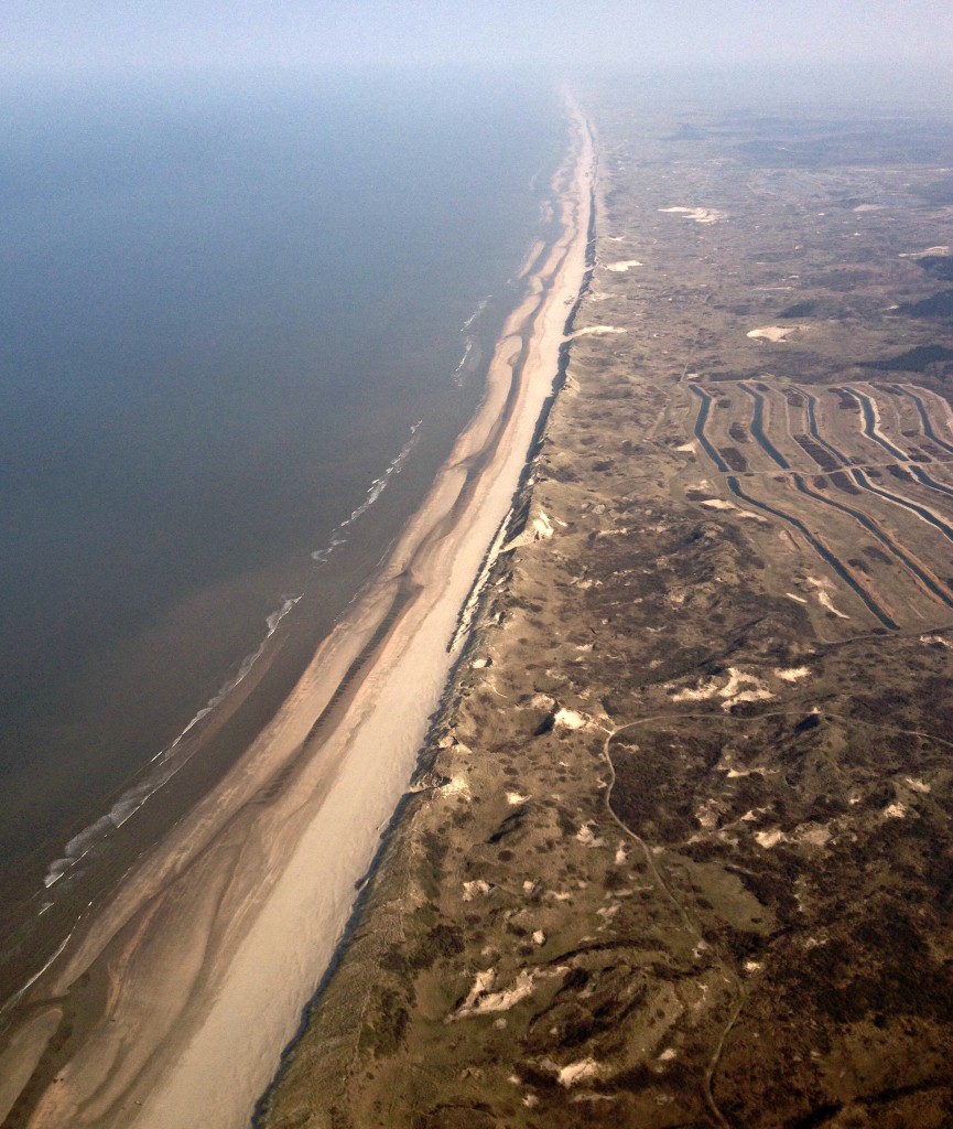 80 pairs of shoes up in the air with british airways gatwick to amsterdam aerial view dutch beach